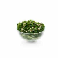 Kale Crunch Side Salad in a transparent bowl.